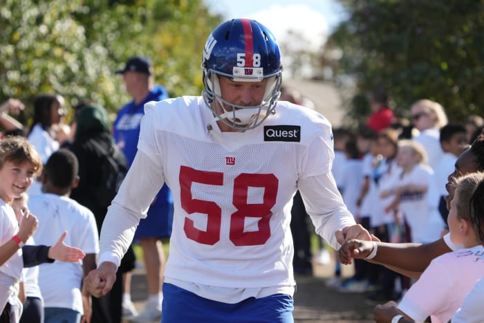 Oct 7,, 2022; Thundridge, United Kingdom; New York Giants long snapper Casey Kreiter (58) is greeted by children during practice at Hanbury Manor.